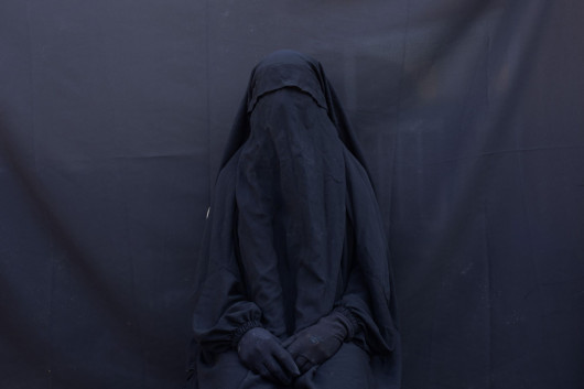 fot. Maya Alleruzzo, USA, Associated Press, z cyklu: Islamic State’s Yazidi Survivors, 2 miejsce w kategorii Contemporary issues - seria zdjęć / World Press Photo 2021

W sierpniu 2014 r. grupa znana jako Państwo Islamskie (Islamic State, IS) przypuściła atak na centrum społeczności Jazydów u podnóża góry Sinjar w północnym Iraku. IS uważa Jazydów za heretyków, a tym samym za ważny cel do eksterminacji, w ich wizji nowego kalifatu rządzonego przez prawo szariatu. Od 2014 r. do czasu, gdy siły amerykańskie i irackie zaczęły wyzwalać ten region w 2017 r., na terytorium kontrolowanym przez IS funkcjonowała gospodarka niewolnicza. W ostatnich latach w mediach pojawiły się doniesienia o kobietach i dzieciach rozdawanych jako prezenty i sprzedawanych w niewolę, za kwotę około 50 USD za kobietę i 35 USD za dziecko. W maju 2020 r. agencja Associated Press doniosła, że chociaż uwolniono około 3500 niewolników, z których większość została wykupiona przez rodziny, los około 2900 Jazydów pozostaje nieznany. Organizacja Narodów Zjednoczonych nazwała te ataki aktem ludobójstwa wobec grupy mniejszościowej. Niezależna Komisja ds. Międzynarodowej Sprawiedliwości i Odpowiedzialności (CIJA), która prowadzi śledztwo w sprawie IS w Iraku od 2015 r., zgromadziła obecnie znaczny materiał dowodowy i relacje świadków z pierwszej ręki w celu skonstruowania akt sprawy, które identyfikują członków IS jako odpowiedzialnych za okrucieństwa, w tym ludobójstwo i inne zbrodnie przeciwko ludzkości.